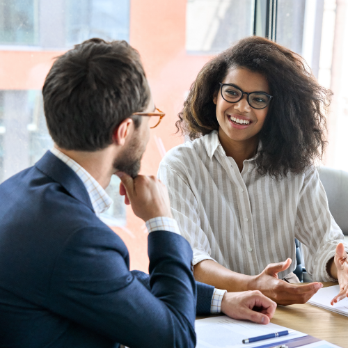 two employees engaging in conversation